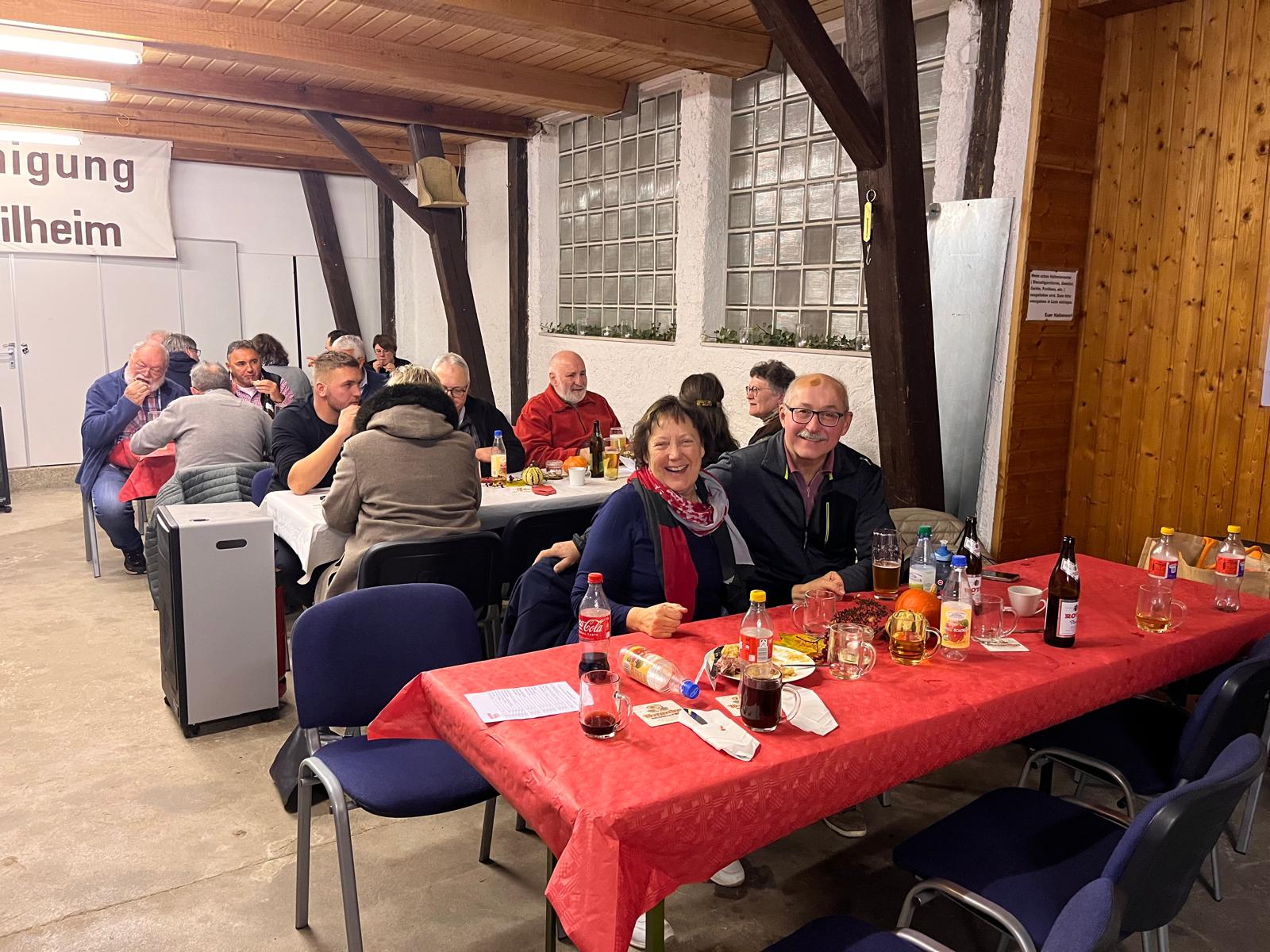 Blick in die Halle beim Novemberfest. Fröhliche Teilnehmer an den Tischen.